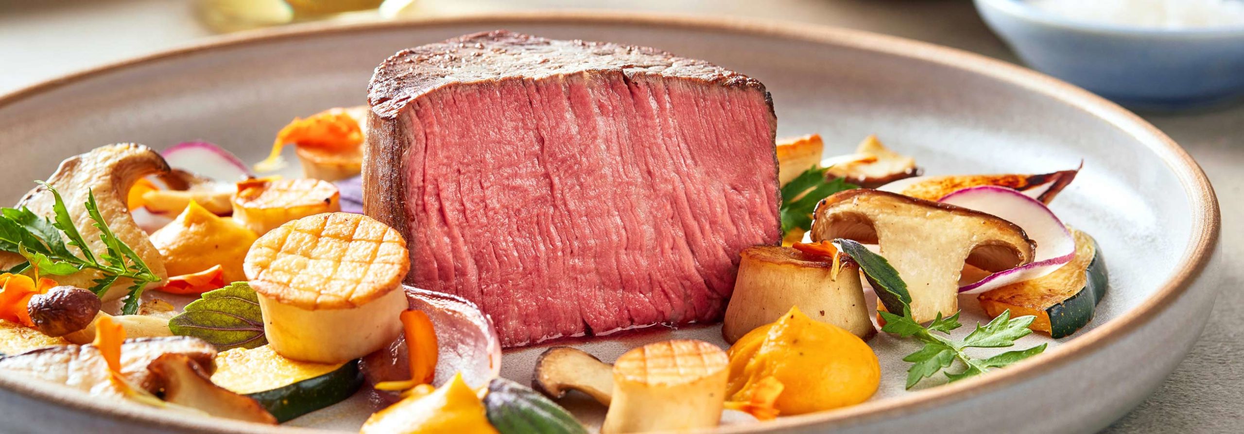 Rare steak cut with roasted vegetables