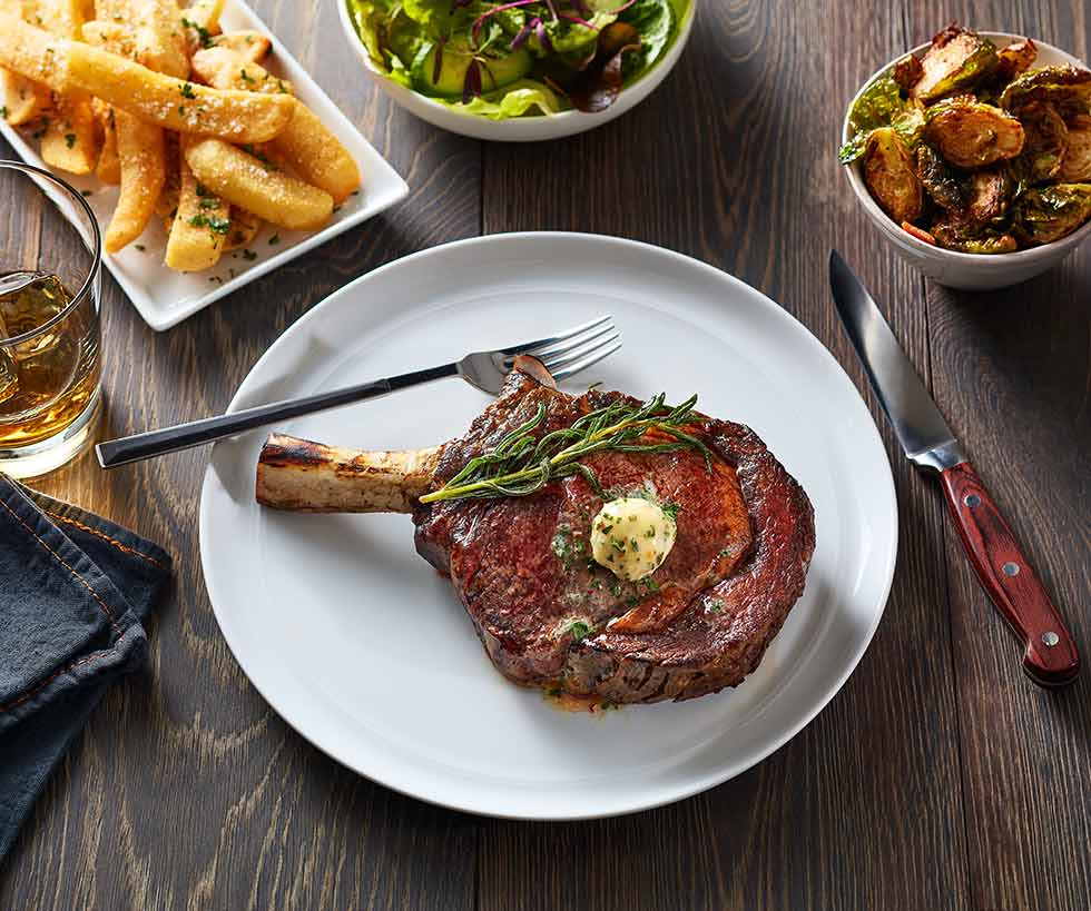 Juicy ribeye with french fries, Brussels sprouts and salad on the side